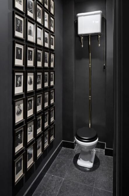 zwarte toilet idee met fotolijsten aan de muur
